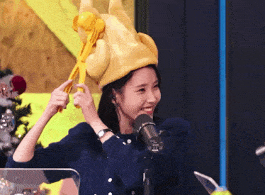 a woman wearing a hat that looks like a chicken