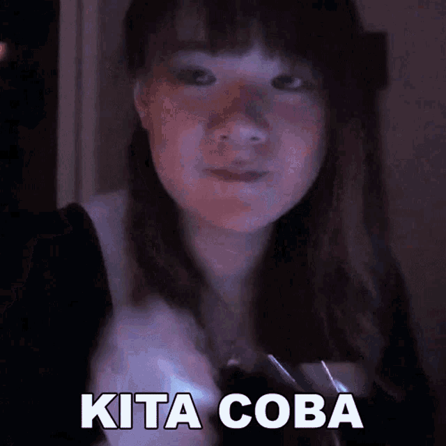 a girl is making a funny face with the words kita coba written on her face