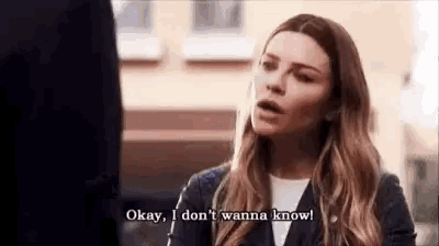 a woman is talking to a man and saying okay , i don 't wanna know .