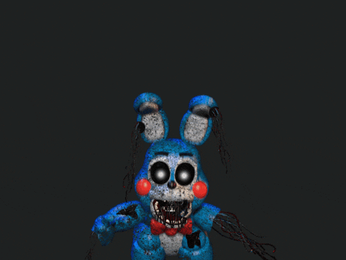 a close up of a blue stuffed animal with big eyes and red cheeks