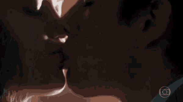 a close up of a man and woman kissing with a circle in the corner