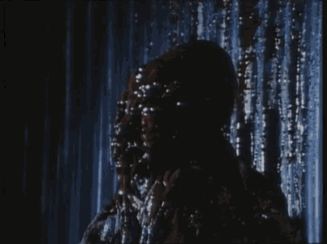 a person is standing in the rain with their face covered in bubbles