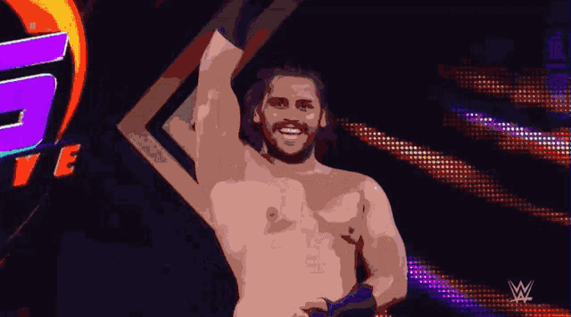 a man without a shirt is standing in front of a wrestling logo