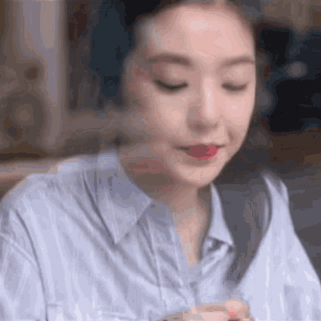 a close up of a woman wearing headphones and a striped shirt