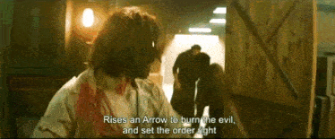 a man in a white shirt says " rises an arrow to burn the evil "