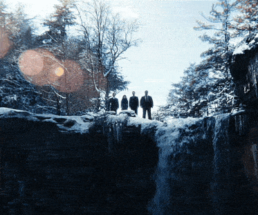 a group of people standing on top of a waterfall