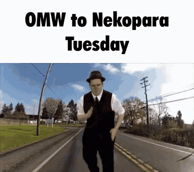 a man in a hat is walking down a street with the words omw to nekopara tuesday above him