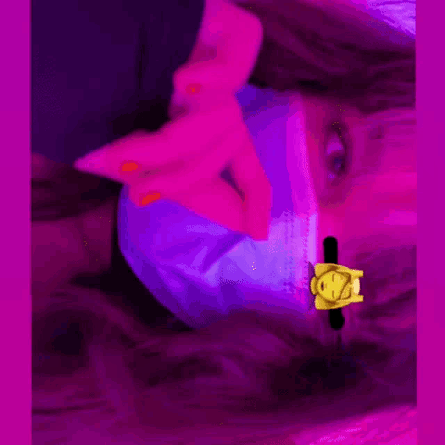 a woman wearing a purple face mask with a yellow sticker on it