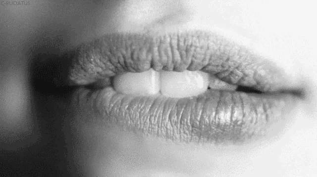 a close up of a woman 's lips with lipstick on them .