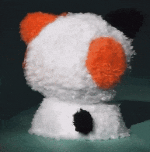 a stuffed animal with orange ears and a black nose