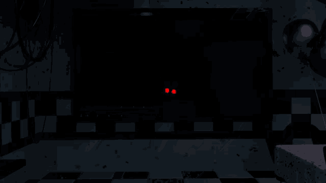 a dark room with a few balloons floating in it
