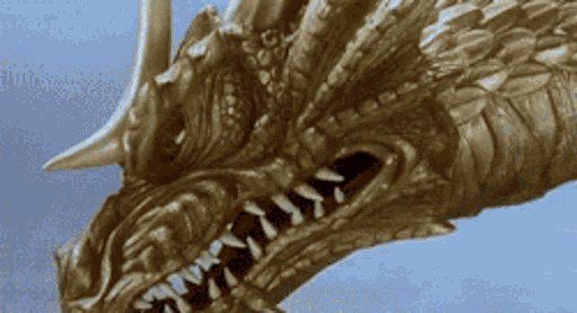 a close up of a dragon 's head with a blue sky in the background
