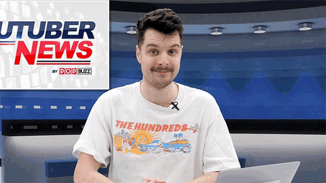 a man wearing a shirt that says the hundreds