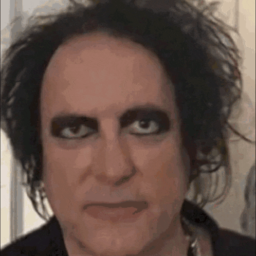 a close up of a man 's face with a lot of makeup on his face .