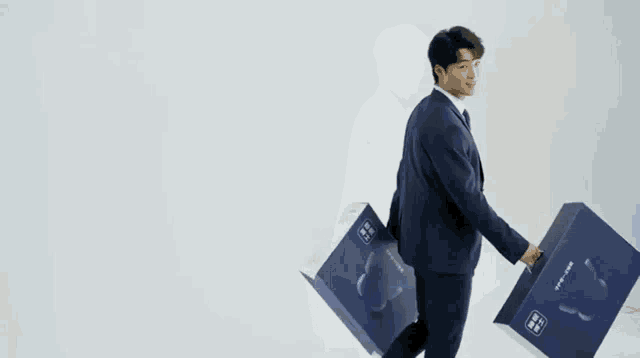 a man in a suit and tie is holding a box that says asleep