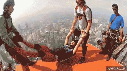 a man is laying on a stretcher with a city in the background and avvegif.com written on the bottom