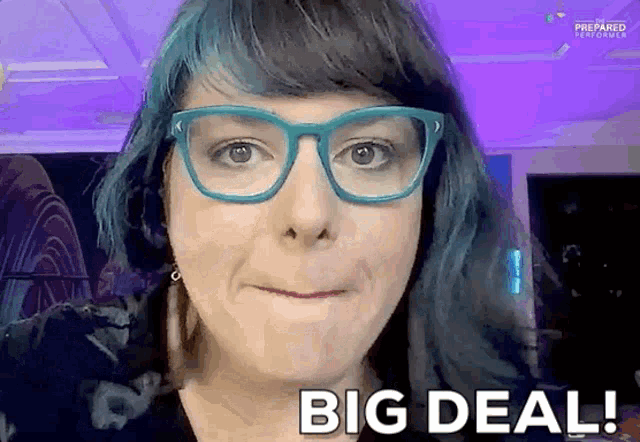 a woman wearing glasses says big deal in front of her face