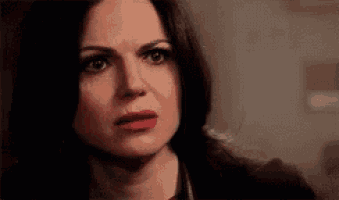 a close up of a woman 's face with a serious expression .