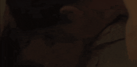a man and a woman are kissing in the dark .