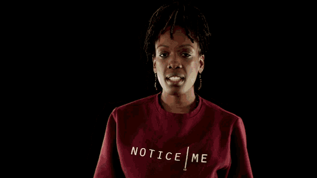 a woman wearing a red sweatshirt with the word tic on the front