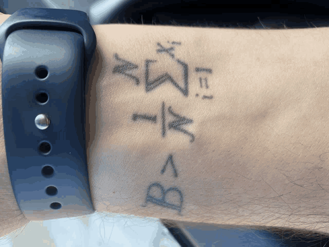 a man has a tattoo on his wrist that says b = a
