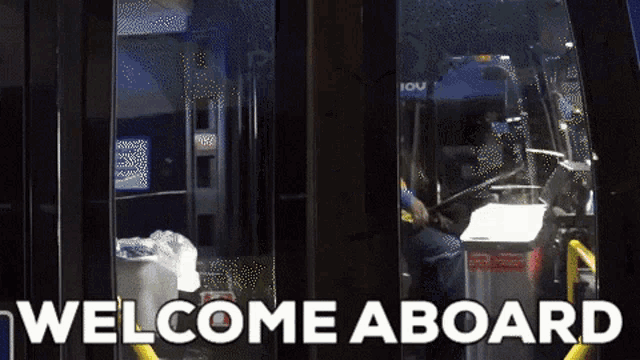 a sign that says welcome aboard with a bus driver in the background