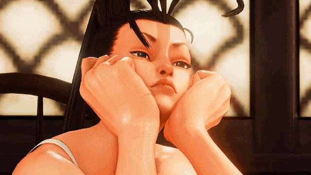 a close up of a woman 's face with her hands on it