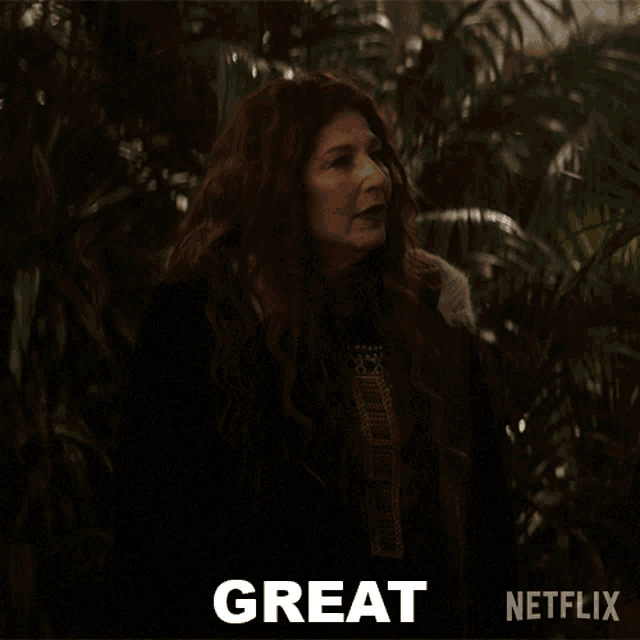 a woman with long red hair is standing in front of a netflix ad