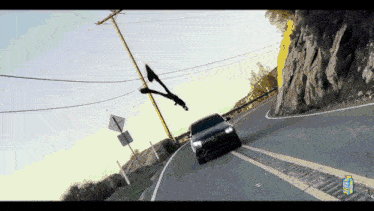 a car is driving down a road with a sign that says ' a ' on it