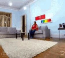 a woman sitting on a couch in a living room