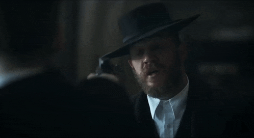 a man in a hat is holding a gun and says " you fucking wha "