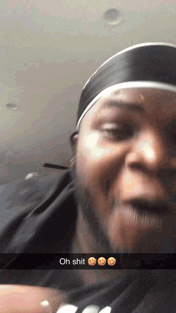 a man wearing a headband and a black shirt says " oh shit "