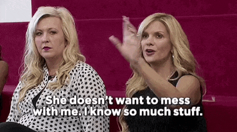 two women are sitting next to each other on a couch .