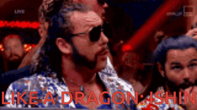 a man with a beard wearing sunglasses and a shirt that says like a dragon shin