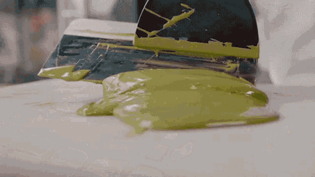 a spatula with green paint on it