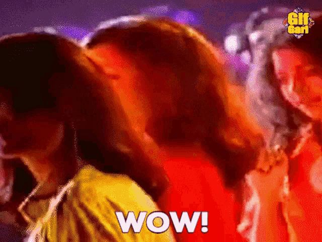 a group of women are dancing in a club and the word wow is being displayed .