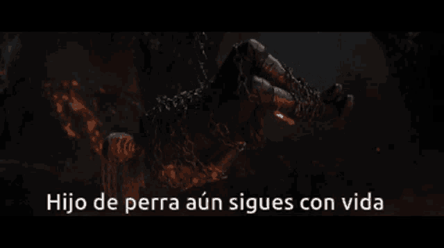 a person is chained to a wall with the words hijo de perra aún sigues con vida above them