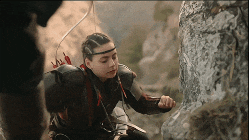a girl with a bow and arrow on her back
