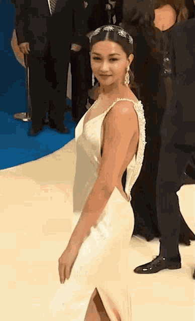 a woman in a white dress with a plunging neckline