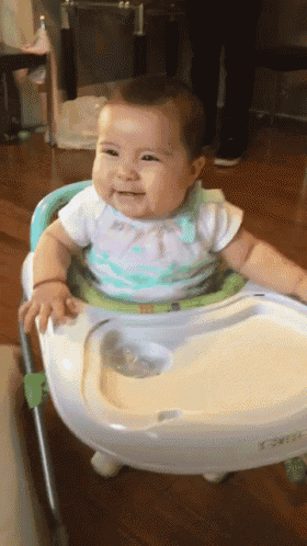 a baby is sitting in a high chair with a tray on it