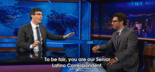a man in a suit and tie talks to another man in a daily show