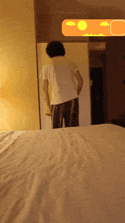 a man in a white shirt is standing in front of a mirror in a bedroom