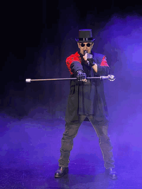 a man in a top hat is holding a cane