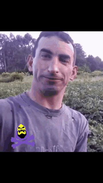 a man wearing a purple shirt with a yellow skull and crossbones