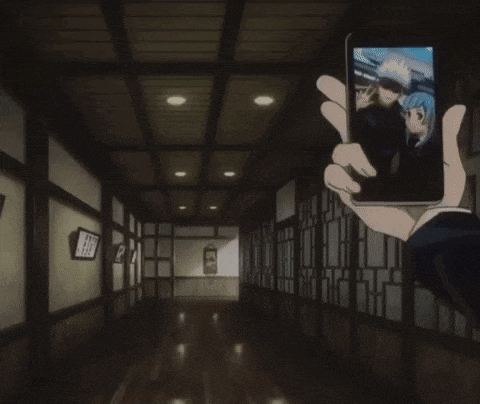 a person with blue hair is taking a selfie in a dark hallway