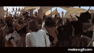 a group of people are standing in a crowd in a movie .