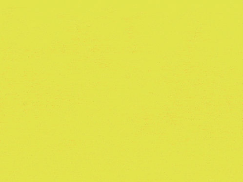 a close up of a yellow and pink triangle shaped object