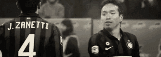 a black and white photo of two soccer players one of whom has the number 4 on his jersey