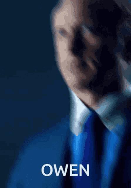 a man in a suit and tie with the name owen written above him