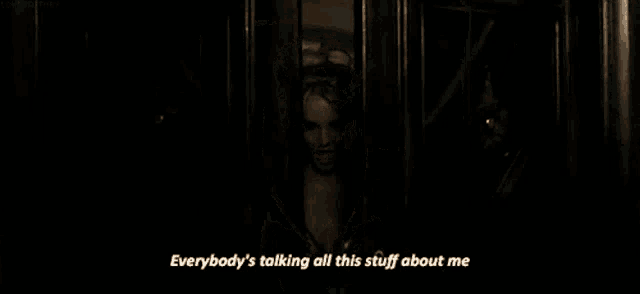 a woman in a black lace top is talking about everybody 's talking all this stuff about her .